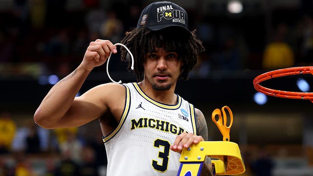 Michigan's Elliot Cadeau gets medical attention before traveling to Final Four
