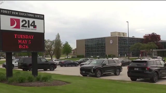 Person of interest in custody after officer’s gun stolen at suburban Chicago school, officials say