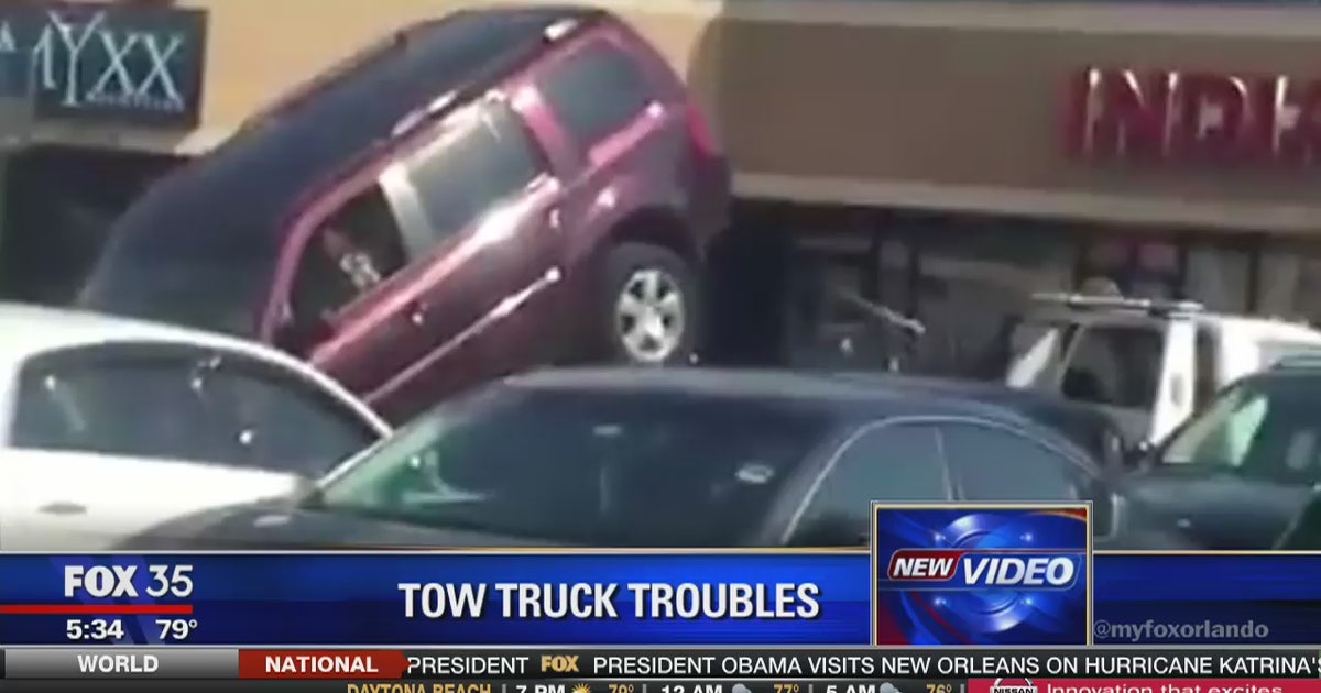VIRAL VIDEO: Man attempts to drive SUV off of tow truck | FOX 35 Orlando