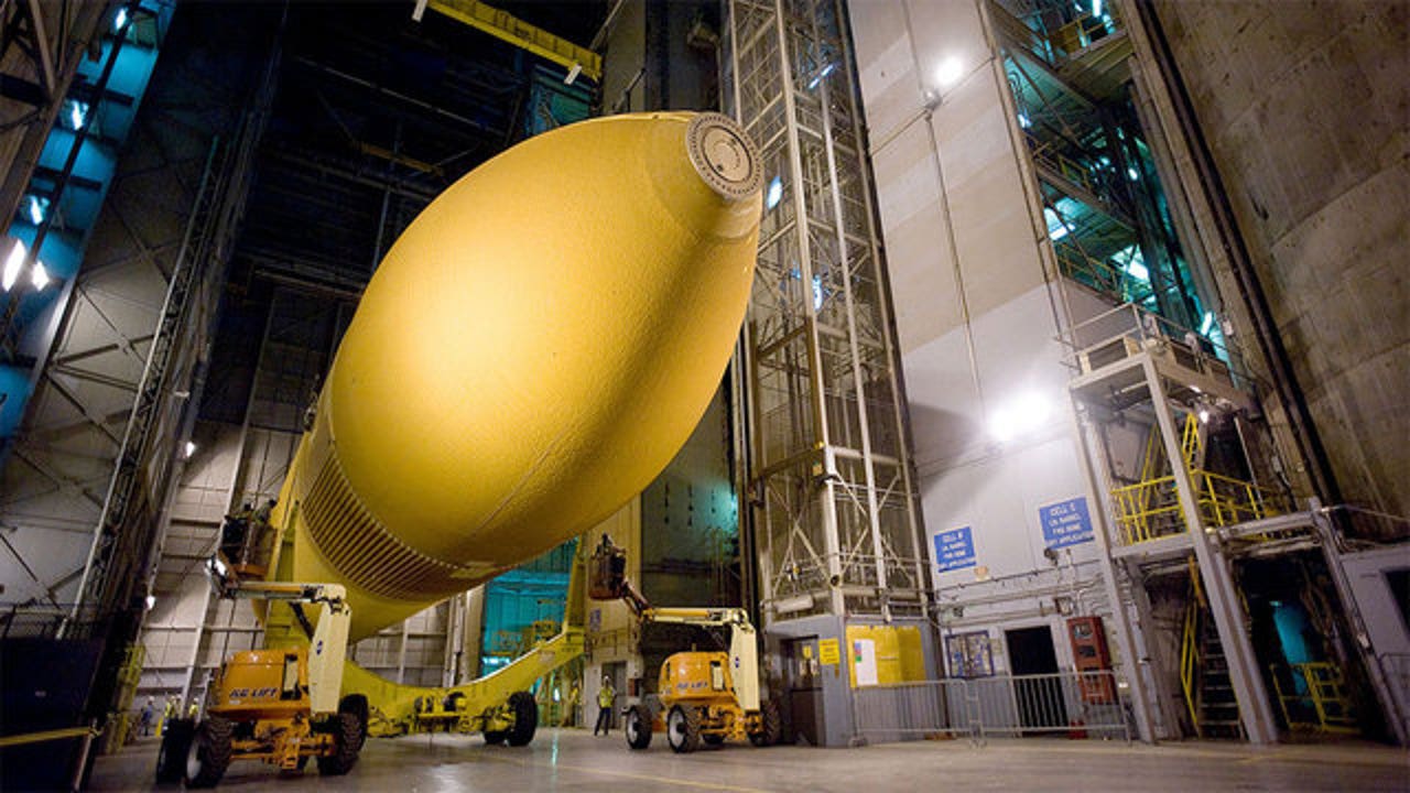 Space shuttle Endeavour's giant orange external tank begins final journey