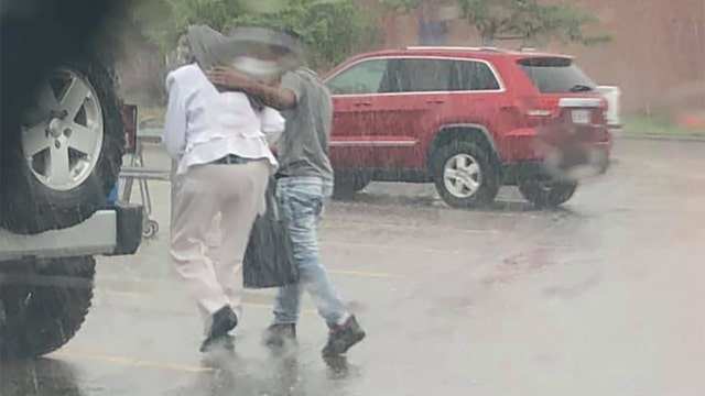 ‘I'm touched by this kid': Officer applauds teen for walking senior citizen to car in rain
