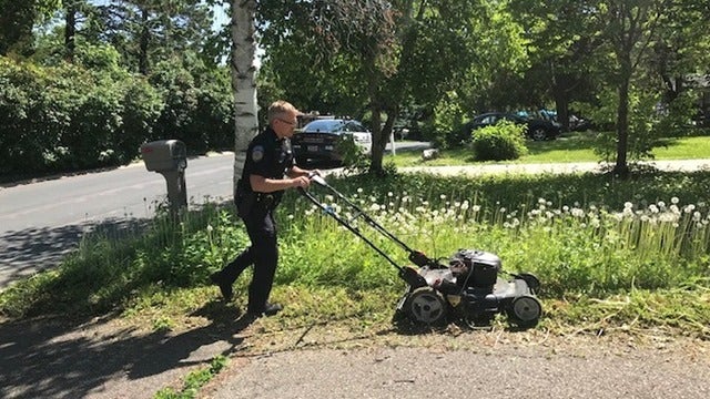 Uniformed Minnesota officer mows woman's lawn after checking on her welfare