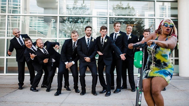 Mystery woman riding scooter photo-bombs wedding party, sparks viral search: 'We love her for it!'