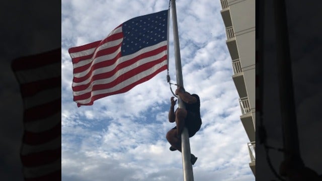 WATCH: Veteran climbs flag pole, fixes American flag at Navy SEAL monument