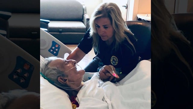 Photo of officer holding hand of homeless man in hospice who has no family goes viral
