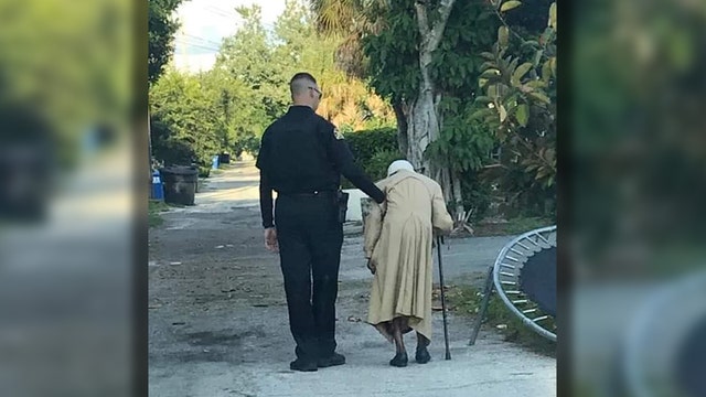Sweet photo shows St. Pete officer walking elderly woman home
