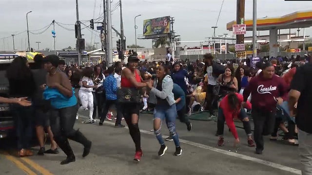 Crowd near Nipsey's Marathon clothing store break through police barriers during funeral procession