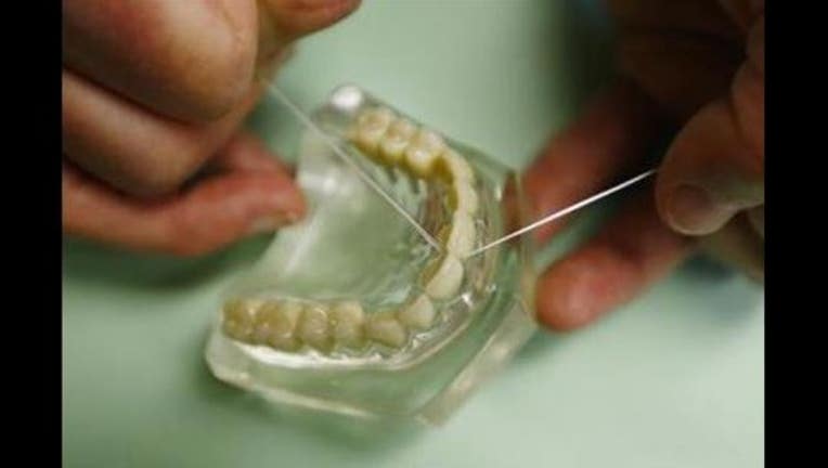 3285b3e5-(AP) flossing teeth