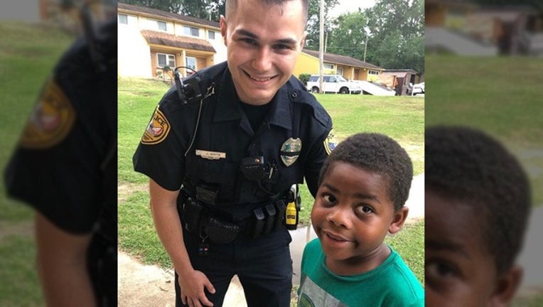 fef9b6fa-CITY OF TALLAHASSEE PD_kid and officer_050819_1557328947996.png.jpg