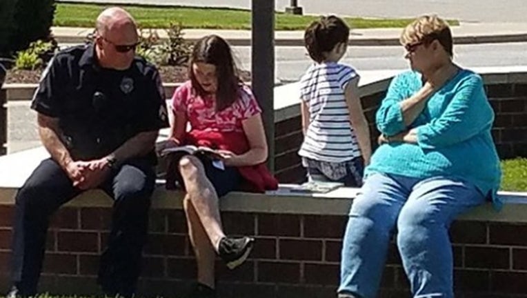 295a542f-Newport Police Department_officer helps children_051219_1557684515419.png.jpg