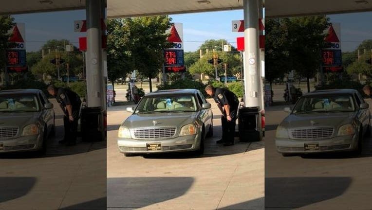 23cce446-SETH KAZZ_police officer helps elderly lady_090618_1536256027578.jpg.jpg