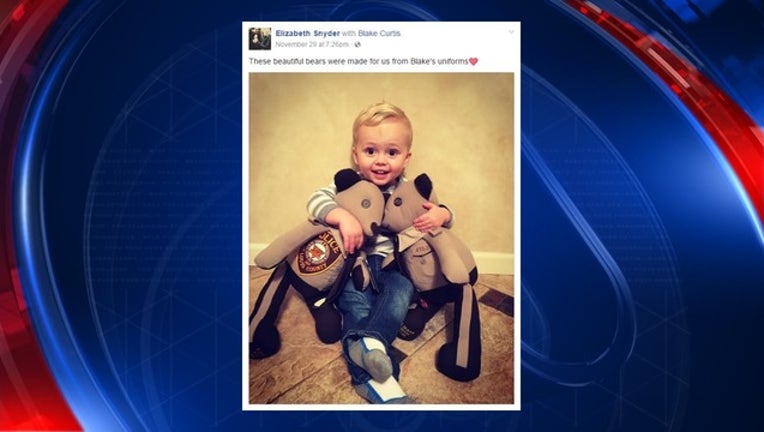 7bed7ea8-Son of slain officer receives toy bears_1480879502646-401720.jpg