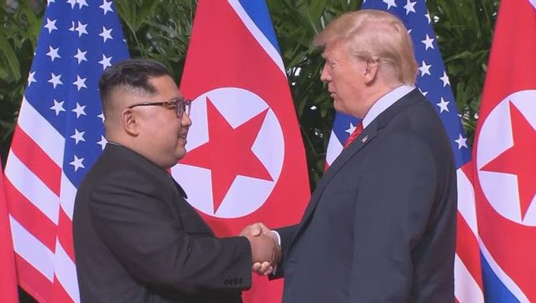 26f67112-Trump Kim Jong Un Shake Hands 2-401720-401720.jpg