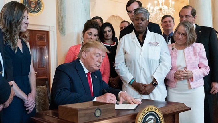 199367a6-WHITE HOUSE_trump signs health bill_062519_1561474796279.png.jpg
