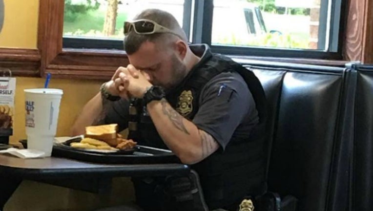 0be2c925-officer prays_1535634267835.jpg-404959.jpg