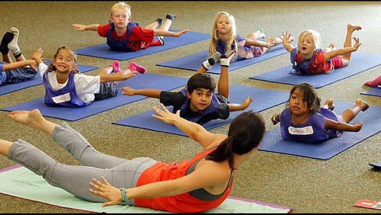 f5f6b049-Kids doing yoga in class