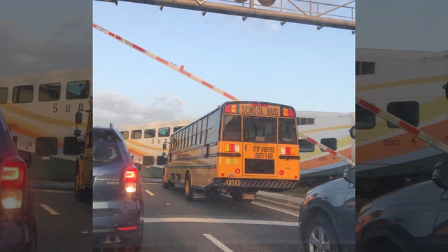 Alarming photo of school bus under train crossing arm leads to investigation