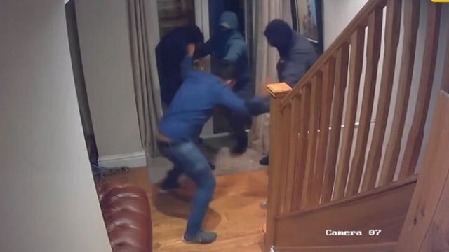 Surveillance video shows outnumbered homeowner fight off intruders with bare hands: report