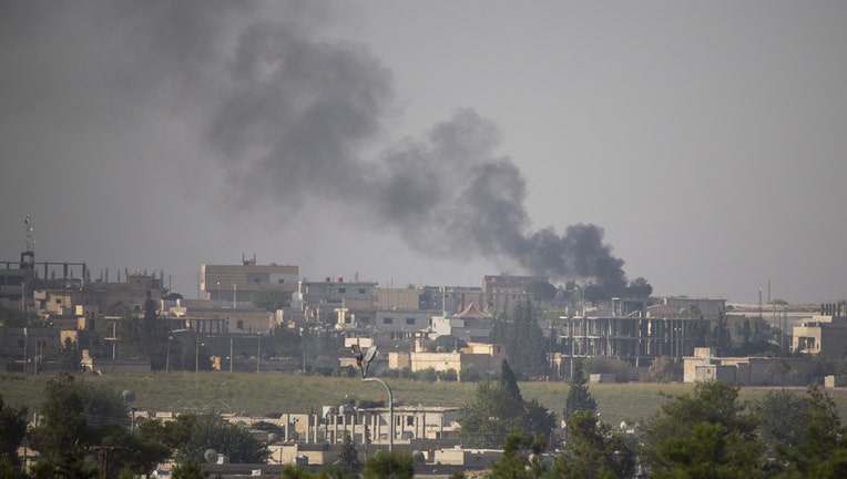 A photo taken from Turkey's Sanliurfa on October 11, 2019 shows black smoke rising in Tell Abyad after terrorists burnt tires and diesel fuel to avoid being targeted and photographed by Turkish National Army's unmanned aerial vehicles (UAV). Turkish troops along with the Syrian National Army (SNA) began Operation Peace Spring against the PKK/YPG and Daesh terrorists east of the Euphrates River in northern Syria to secure its borders by eliminating terrorist elements and to ensure the safe return of Syrian refugees as well as Syrias territorial integrity. (Photo by Emin Sansar/Anadolu Agency via Getty Images)