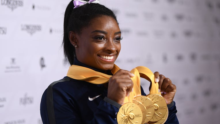 STUTTGART, GERMANY - OCTOBER 13: Simone Biles of USA poses with her Medal haul after the Apparatus Finals on Day 10 of the FIG Artistic Gymnastics World Championships at Hanns Martin Schleyer Hall on October 13, 2019 in Stuttgart, Germany. (Photo by Laurence Griffiths/Getty Images)