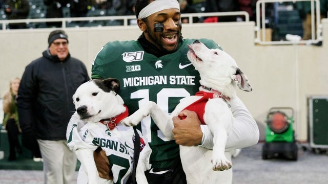College football player who lost both parents in 2 years celebrates Senior Day with his dogs