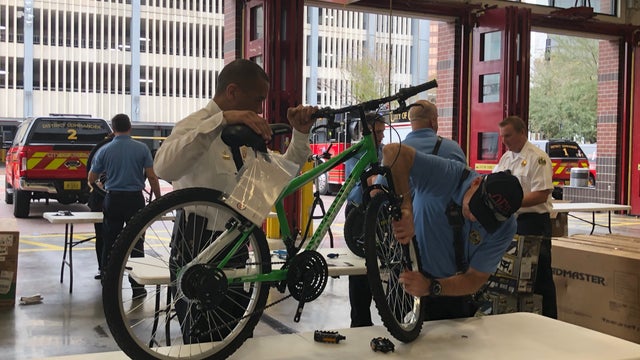 Orlando firefighters assemble bikes for kids ahead of Christmas