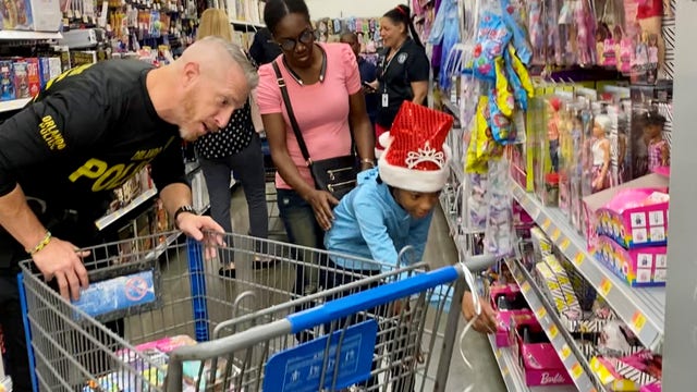 Dozens of kids Shop with a Super Cop in Orlando Walmarts