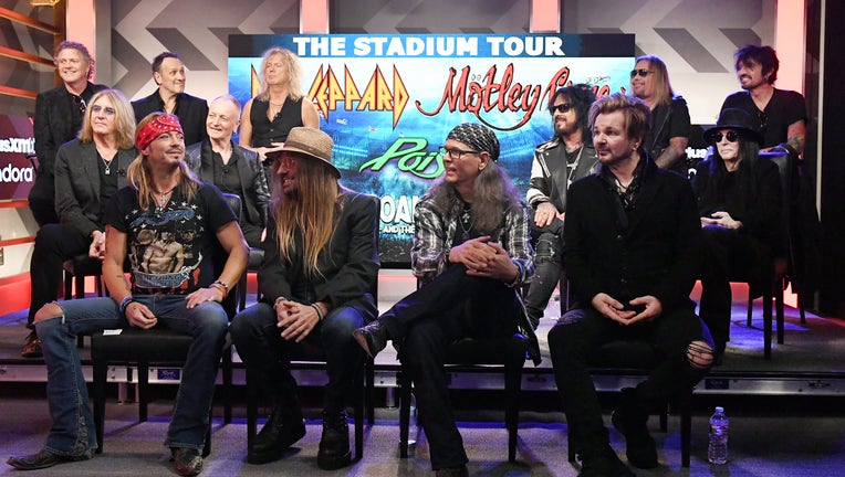 HOLLYWOOD, CALIFORNIA - DECEMBER 04: (Back of stage L-R) Rick Allen, Joe Elliott, Vivian Campbell, Phil Collen, and Rick Savage of Def Leppard, Nikki Sixx, Vince Neil, Mick Mars, and Tommy Lee of Mötley Crüe, and (Front of stage L-R) Bret Michaels, C.C. DeVille, Bobby Dall, and Rikki Rockett of Poison attend the Press Conference with Mötley Crüe, Def Leppard, and Poison announcing 2020 Stadium Tour on December 04, 2019 in Hollywood, California. (Photo by Kevin Winter/Getty Images)