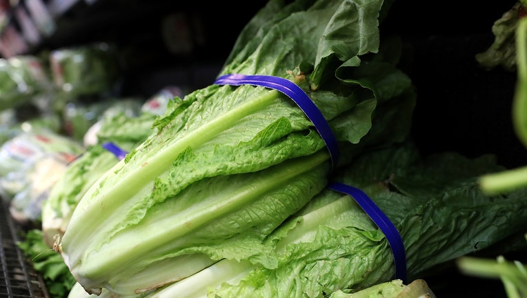 FILE - Romaine lettuce is displayed on a shelf at a supermarket.