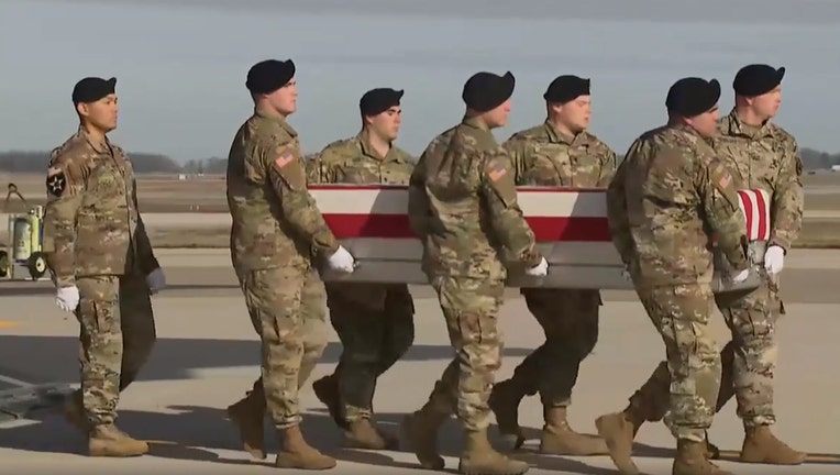 U.S. service members carry a casket containing the remains of Sgt. 1st Class Michael J. Goble from a transport plane to a van at Dover Air Force Base in Delaware, Dec. 25, 2019.