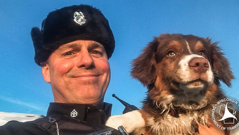 Trooper Jones and River, the dog he helped locate after its owner got in a car crash.