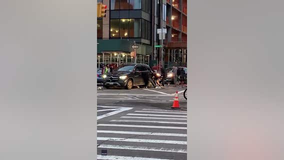 Crowd lifts vehicle to free trapped woman