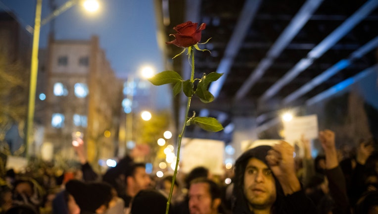 An Iranian protester (Not pictured) holds-up a flower as she attends in front of a University to mark the memory of the victims of the Ukraine Boeing 737 passenger plane in Tehrans business district on January 11, 2020. Irans Revolutionary Guard Corps (IRGC) said on January 11th that they have shut down the Ukrainian passenger plain during a wrong attach as they were ready for the U.S. possible missile attack against the 52 targets in Iran. (Photo by Morteza Nikoubazl/NurPhoto via Getty Images)