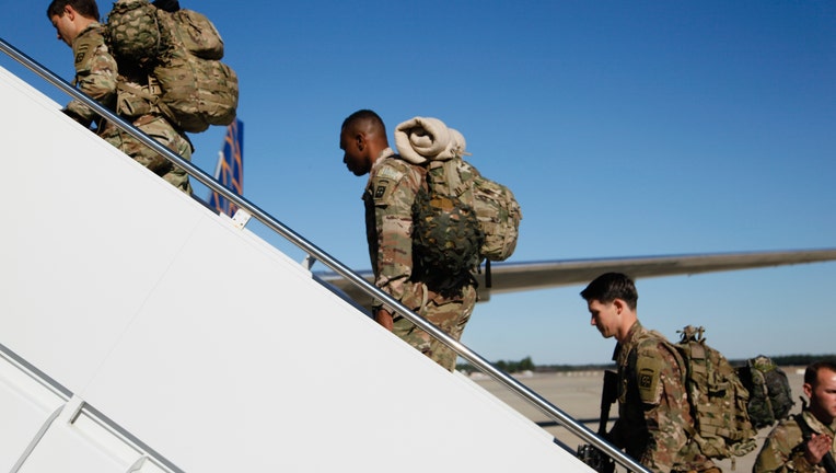 38203787-Paratroopers assigned to 1st Brigade Combat Team, 82nd Airborne Division load aircraft bound for the U.S. Central Command area of operations from Fort Bragg, N.C.
