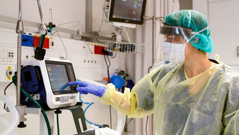 This picture taken during a press presentation of the hospitalization service for future patients with coronavirus at Samson Assuta Ashdod University Hospital in the southern Israeli city of Ashdod shows the director of the epidemics service Dr Karina Glick checking a medical ventilator control panel at a ward on March 16, 2020.