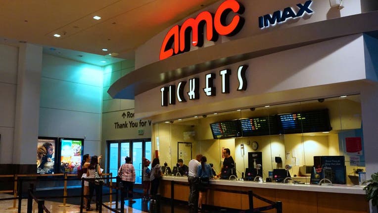 FILE - Movie goers purchase automated tickets at an AMC movie theater in Arcadia, California on Aug. 2, 2017. 