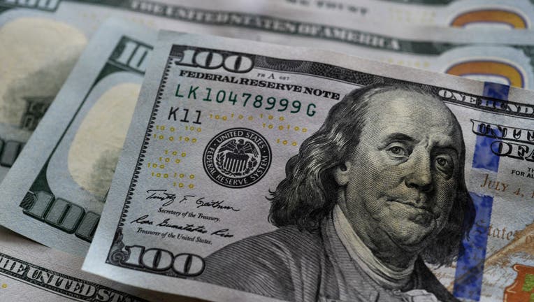 In this photo illustration $100 banknotes are seen displayed.