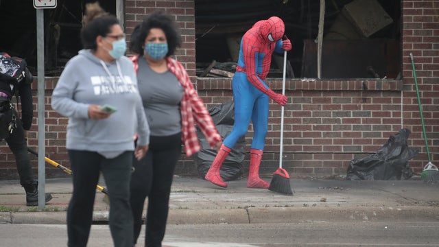 Volunteers clean up trash, graffiti and debris following Twin Cities protests