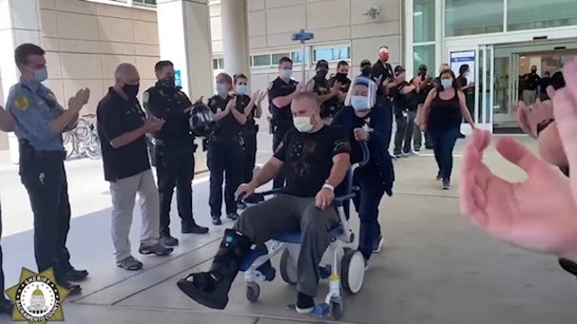 Deputy injured in gun battle gets guard of honor as he's discharged from hospital