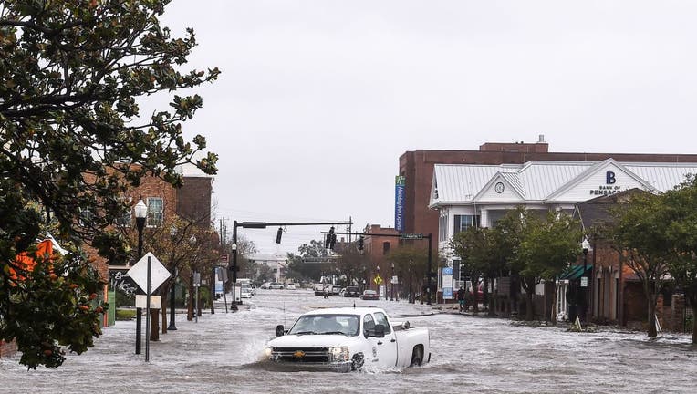 A city worker drives through the flooded street during Hurricane Sally in downtown Pensacola, Florida on September 16, 2020.