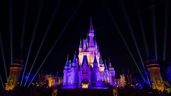Cinderella's Castle at Magic Kingdom lights up in purple and gold after Los Angeles Lakers win NBA Finals