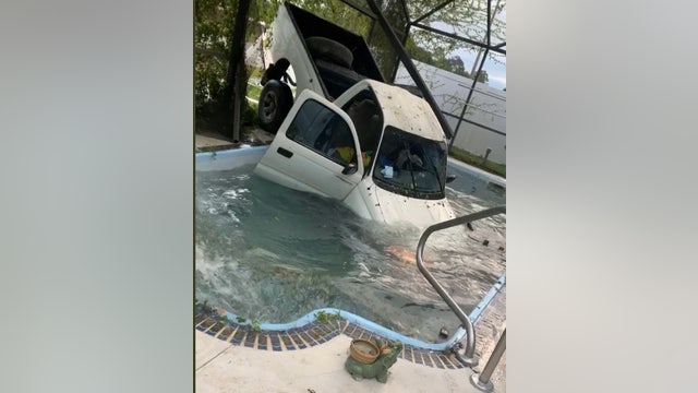 Truck crashes through patio, lands in swimming pool in Kissimmee