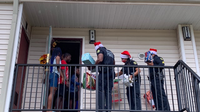 Orlando police officers deliver toys to children