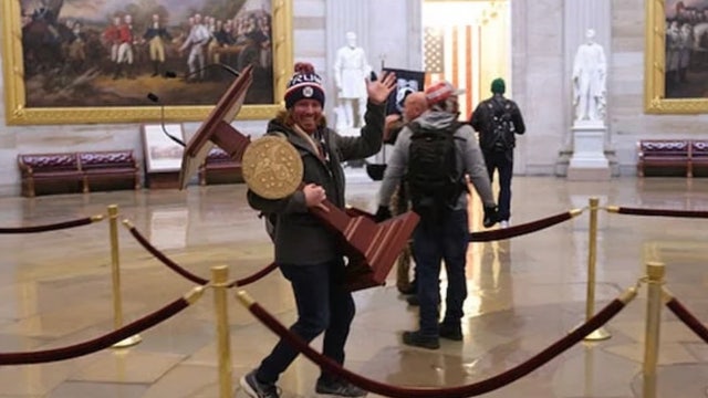 Florida man identified in Capitol riot viral photo carrying US House lectern: report
