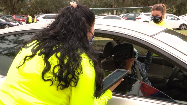 Health officials help Latino residents register for vaccine appointments