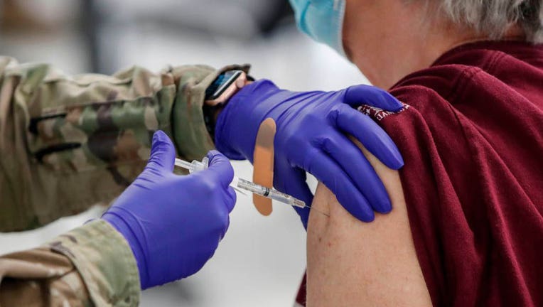 FILE - A woman receives a Pfizer COVID-19 vaccine at a vaccination center established at the Triton College in River Grove, Illinois, on Feb. 3, 2021. (Photo by KAMIL KRZACZYNSKI/AFP via Getty Images)