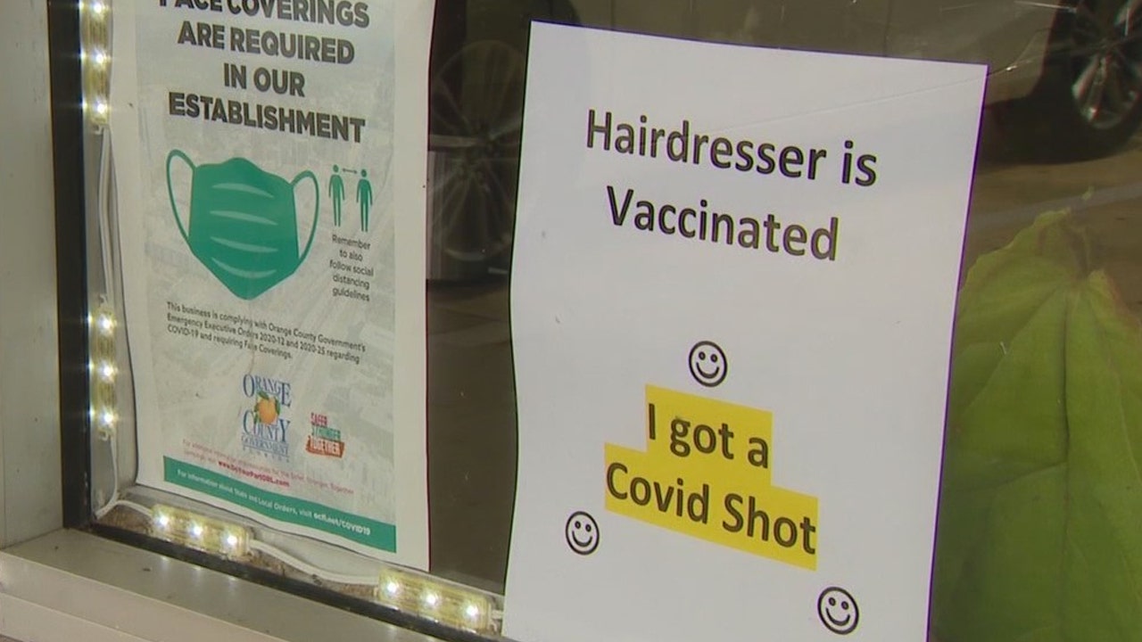 Florida hairstylist hangs 'hairdresser is vaccinated' sign to