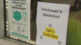 Florida hairstylist hangs 'hairdresser is vaccinated' sign to welcome customers back in