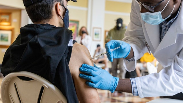 US colleges divided over requiring student COVID-19 vaccinations