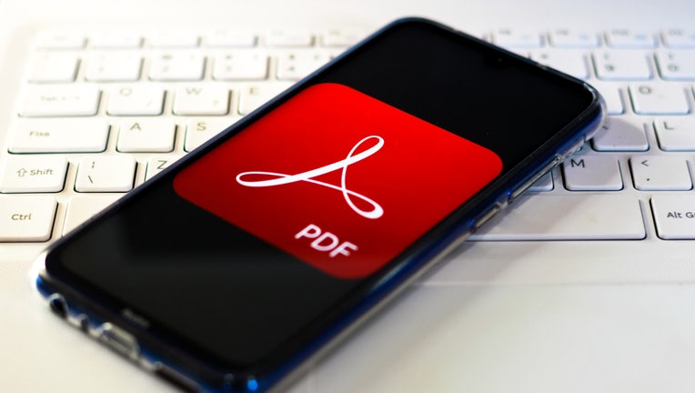 In this photo illustration the Adobe Acrobat logo is